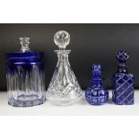 Group of assorted cut glass to include two blue flash glass decanters, a cut glass decanter and a