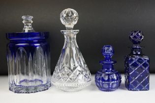 Group of assorted cut glass to include two blue flash glass decanters, a cut glass decanter and a
