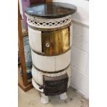 Early 20th century French Cast Iron and Ceramic Circular Stove with marble top, the cast iron door