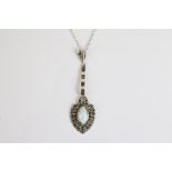 A silver and marcasite necklace set with opal panel