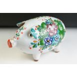 20th Century Italian ceramic faience piggy bank having a white ground with painted floral sprays.