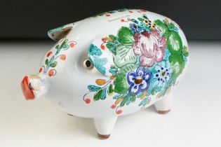 20th Century Italian ceramic faience piggy bank having a white ground with painted floral sprays.