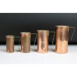 Set of four copper graduating cup measures, with brass handles, ranging from 1/4 cup to 1 cup (