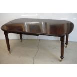 19th century Mahogany Dining Table, the top with curved ends and two additional leaves, raised on