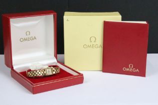 A ladies Omega 9ct gold cased wristwatch with hallmarked 9ct gold bracelet strap, Omega logo to