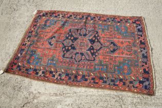 Eastern Kashqai Red Ground Wool Rug with geometric pattern within a border, approx. 205cm x 140cm