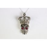 An unusual silver skull shaped pendant necklace