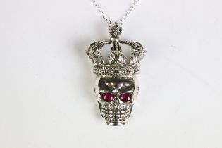 An unusual silver skull shaped pendant necklace