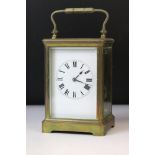 20th Century brass carriage clock having bevelled glass sides, swing handle to top and a roman