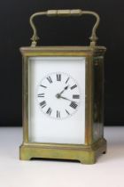 20th Century brass carriage clock having bevelled glass sides, swing handle to top and a roman