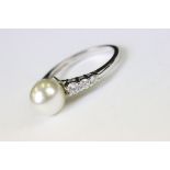 A silver CZ and freshwater pearl dress ring.