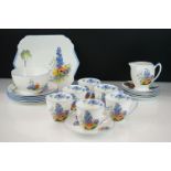Art Deco Shelley coffee service having a white ground with floral sprays to each and blue rims and