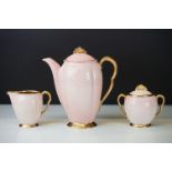 Carlton Ware Art Deco Rita coffee set. The set having pink bodies with gilt interiors and fan shaped