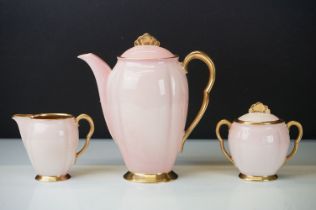 Carlton Ware Art Deco Rita coffee set. The set having pink bodies with gilt interiors and fan shaped