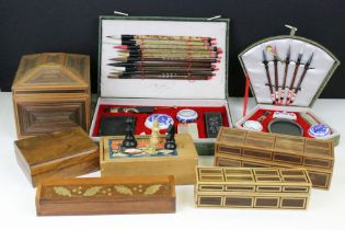 Two Chinese brush sets with associated accessories, and a collection of assorted wooden boxes.