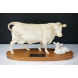 Beswick Connoisseur Charolais cow and calf mounted on a wooden plinth base. Measures 23cm wide.