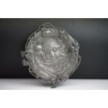 An Art Nouveau WMF pewter tray, by Albert Mayer, cast in low relief with the portrait of a girl, the