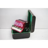 Scarlatti accordion having 22 keys and 8 base keys with a red case. Set within original leather