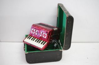 Scarlatti accordion having 22 keys and 8 base keys with a red case. Set within original leather