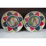 Pair of Royal Vienna wall plates having printed designs to the centre featuring garden scenes with