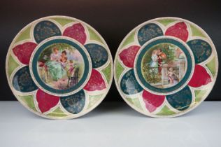 Pair of Royal Vienna wall plates having printed designs to the centre featuring garden scenes with