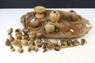 Collection of treen ware to include miniature turned vases, cups and fruit, together with a carved