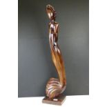 Carved hardwood sculpture of a stylised woman, raised on a square base. (Approx 89cm high)