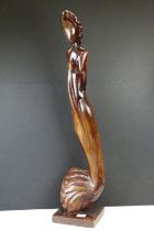 Carved hardwood sculpture of a stylised woman, raised on a square base. (Approx 89cm high)