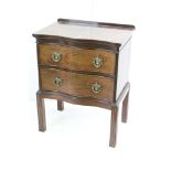 George III style Mahogany Chest of Two Drawers of serpentine outline, raised on square fluted