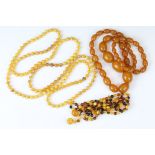 Three beaded necklaces to include one butterscotch amber style necklace, an amber beaded necklace