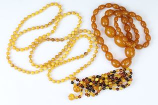 Three beaded necklaces to include one butterscotch amber style necklace, an amber beaded necklace