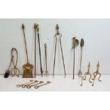 Group of brass fire irons to include assorted tongs, poker, brush fire dogs, ornamental keys etc.