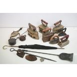 Collection of assorted 19th Century irons including a pots irons, bamboo handled umbrella, and