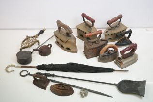 Collection of assorted 19th Century irons including a pots irons, bamboo handled umbrella, and