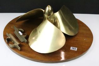 Vintage brass three-blade boat propellor mounted on an oval wooden wall plaque. (Overall width