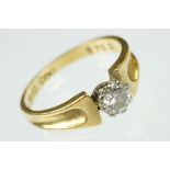 Diamond solitaire 18ct yellow and white gold set ring, the round brilliant cut diamond weighing