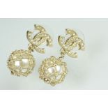 Pair of Chanel costume jewellery earrings having crossed C's to the heads set with simulated