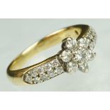 Diamond flower head 18ct yellow gold ring, the centre round brilliant cut diamond weighing approx
