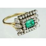 Emerald and diamond 18ct yellow and white gold cluster ring, the central emerald cut emerald
