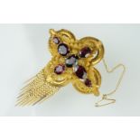 Early Victorian garnet yellow metal brooch, seven graduated oval mixed cut garnets, the largest