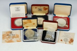 A Small Collection Of Cased Silver Proof Coins To Include 1977 Commemorative Crowns And A Mother