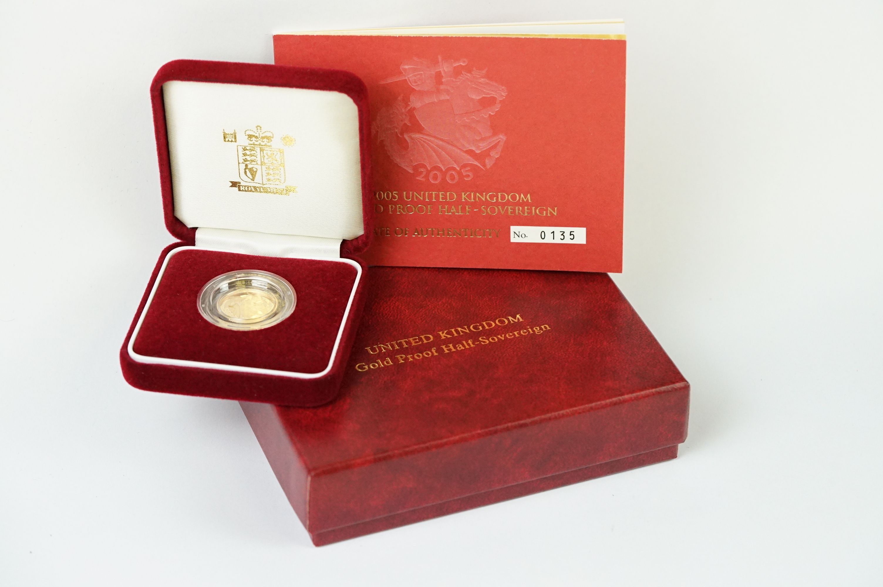 A Royal Mint United Kingdom 2005 gold proof half sovereign coin, encapsulated and set within red