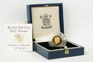 A British Royal Mint Queen Elizabeth II 1998 gold proof half sovereign coin within blue Royal Mint