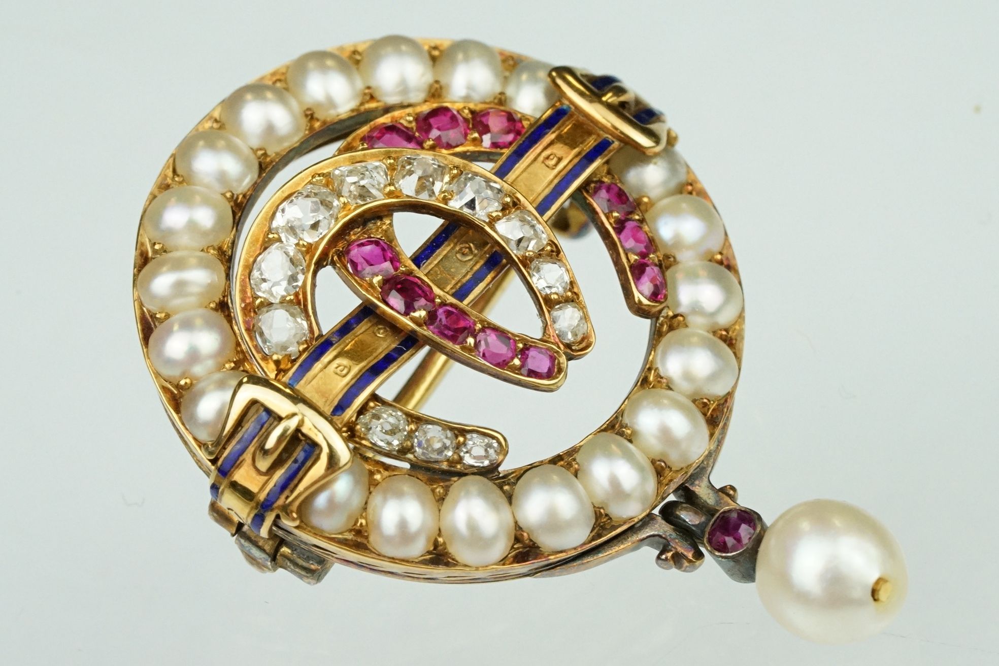 19th century ruby, diamond and pearl brooch, the two central entwined horse shoe motifs set with
