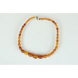Butterscotch amber necklace, thirty-nine graduated oval beads, the smallest bead measuring approx