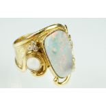 Opal, moonstone and diamond 18ct yellow gold ring, the precious white opal displaying indigo,