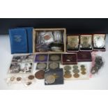 A collection of mixed foreign and British pre decimal coins to include uncirculated sets, crowns,