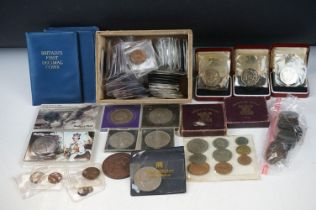 A collection of mixed foreign and British pre decimal coins to include uncirculated sets, crowns,