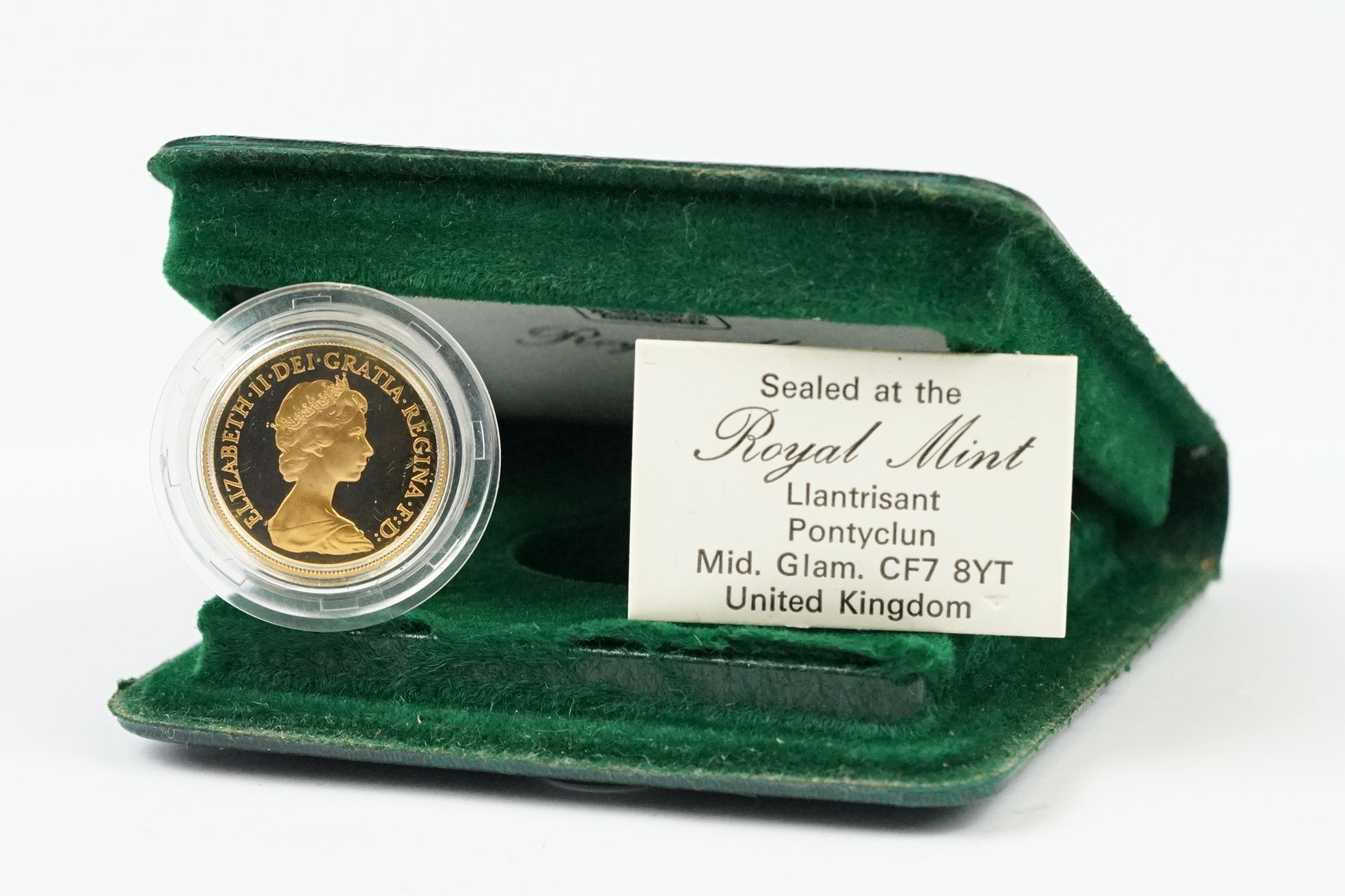 A British Royal Mint Queen Elizabeth II 1980 gold proof full sovereign coin within green Royal