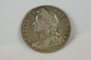 A British King George II 1728 silver sixpence coin.
